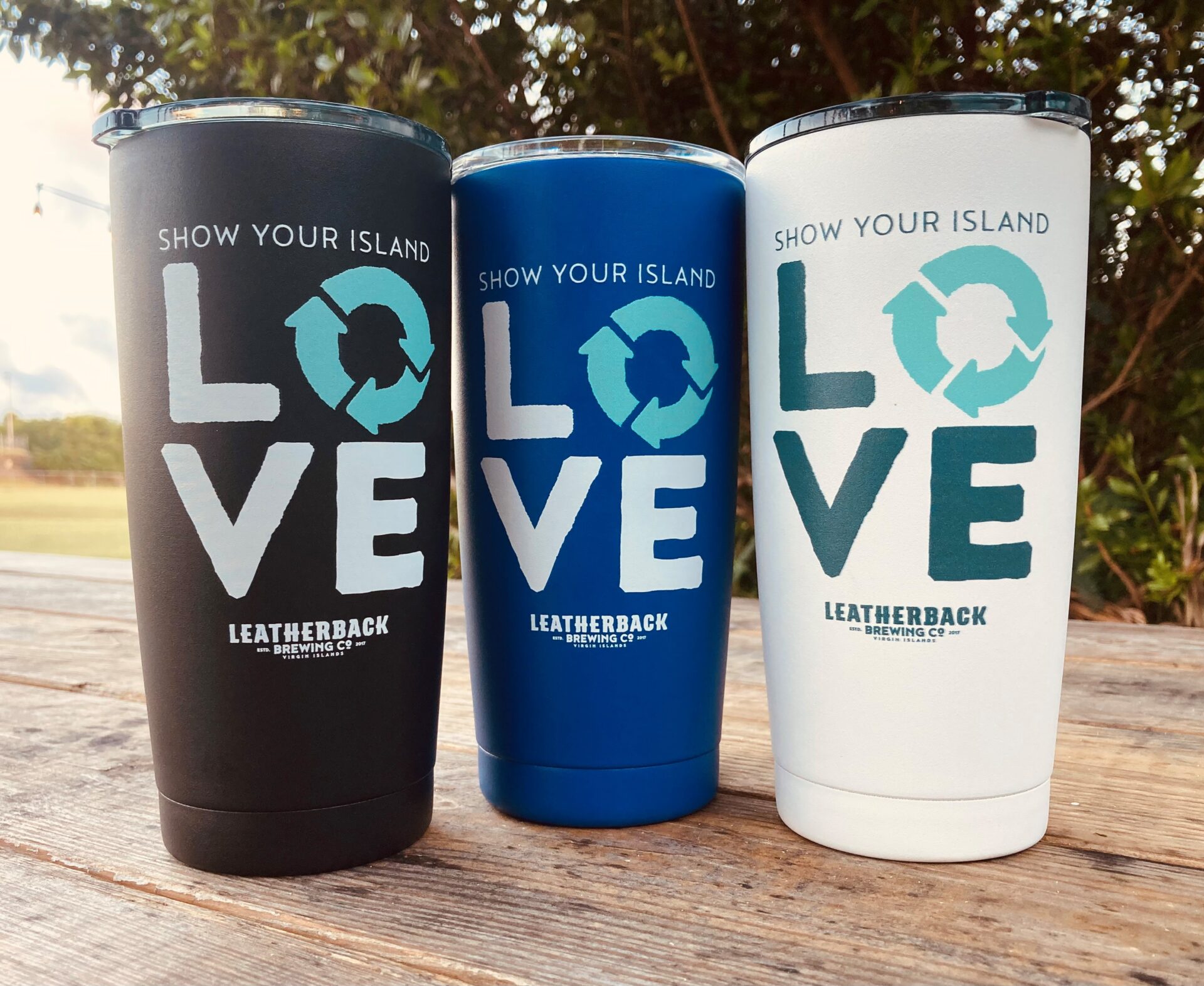 Three cups that are sitting on a table.