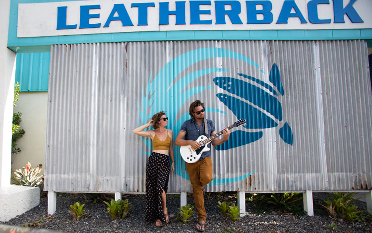 A man and woman standing in front of a building.
