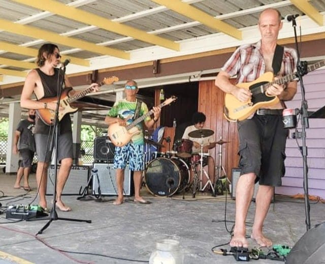 A group of people playing guitar and drums